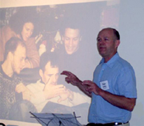 Peter Leidy in front of a screen doing a presentation like you would watch on the dvd